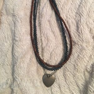 Beaded necklace with silver heart charm.